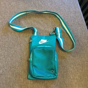 Teal Nike sport summit crossbody bag, pretty roomy, and adjustable strap.